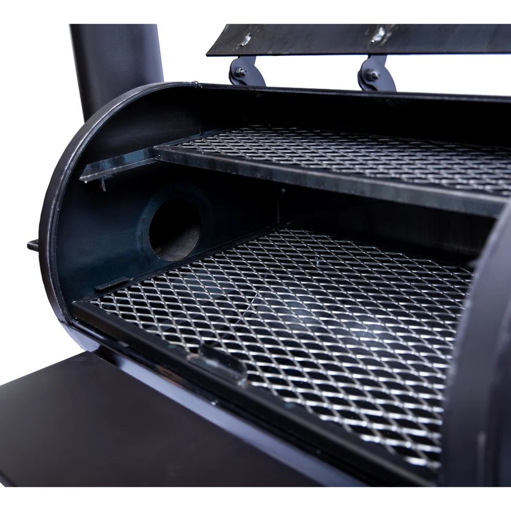 Close-up of a black barbecue grill with metal grates on a white background