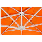 Close-up of an orange patio umbrella canopy with white metal support ribs radiating from a central hub.