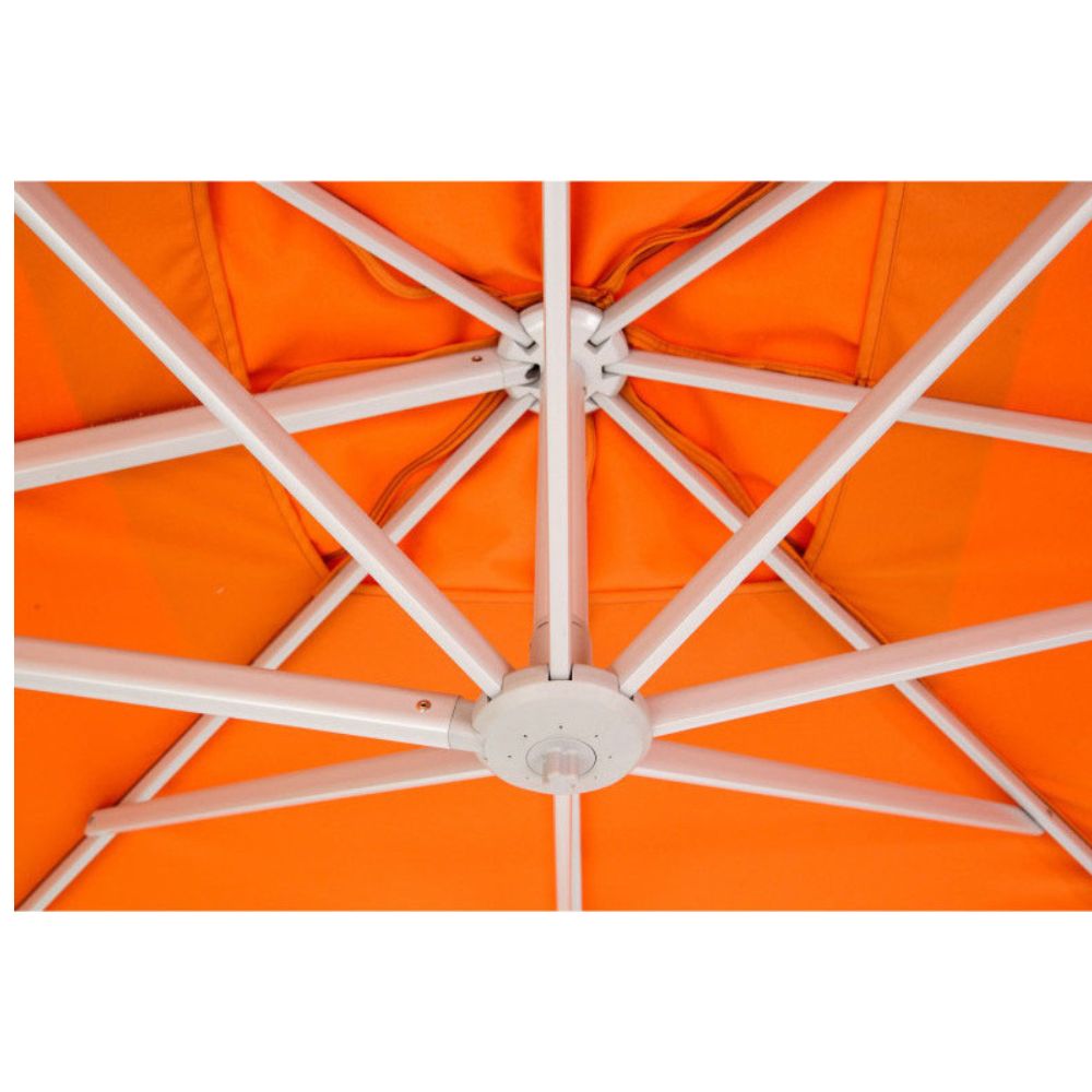 Close-up of an orange patio umbrella canopy with white metal support ribs radiating from a central hub.