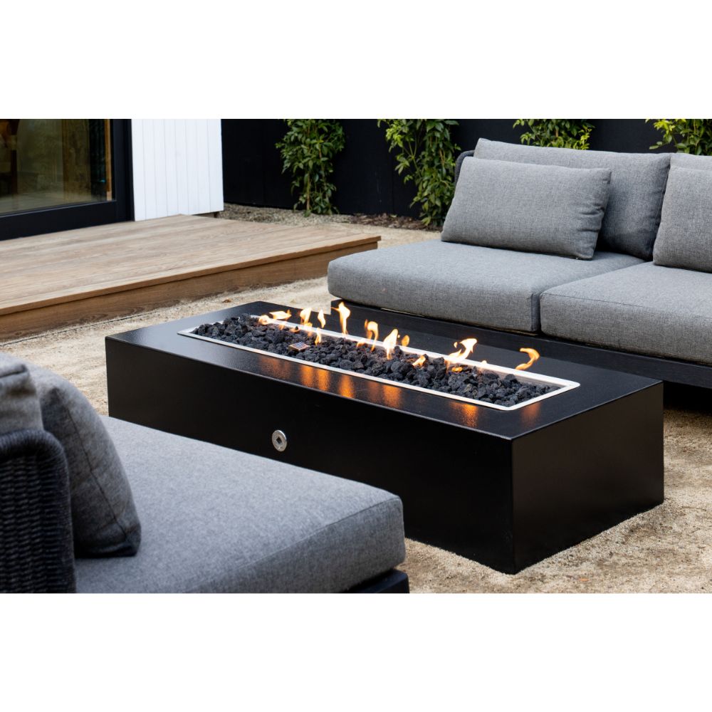 Outdoor patio with a fire pit table and gray sofa