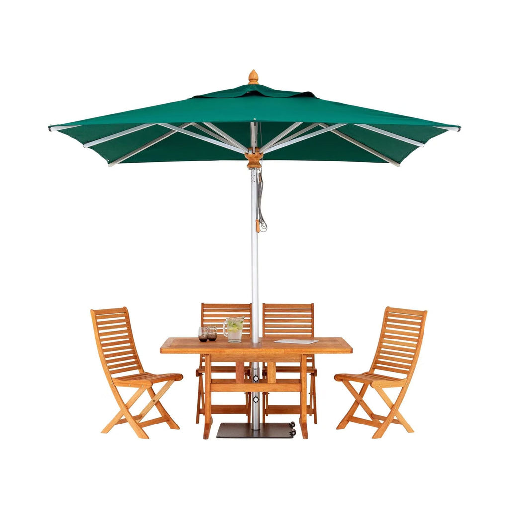 Teak outdoor dining set with a square table, four folding chairs, and a green patio umbrella on a white background.