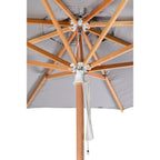Close-up of an outdoor patio umbrella showing the underside with natural wood ribs, a gray fabric canopy, and a white hanging pull cord on a white background.