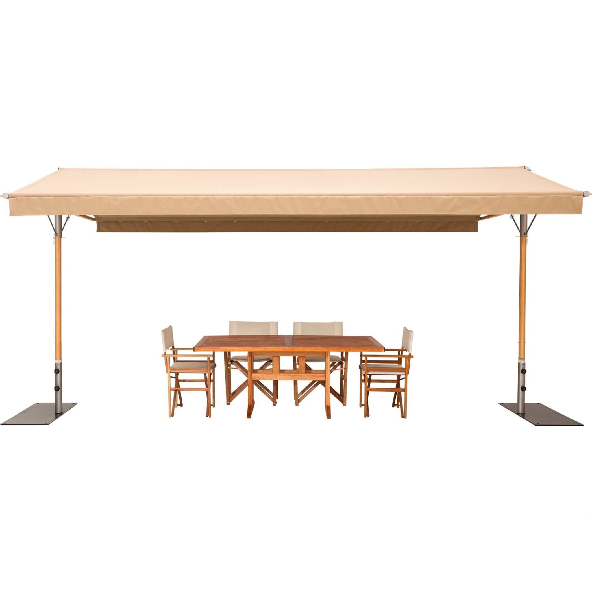 A beige retractable patio canopy with metal support poles and square ground anchors, shown with a wooden dining table and four chairs underneath on a plain white background.
