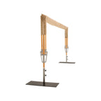 A freestanding rectangular patio umbrella shown open on a white background, with a beige fabric canopy, orange pole sections, silver metal supports, and a dark metal base.