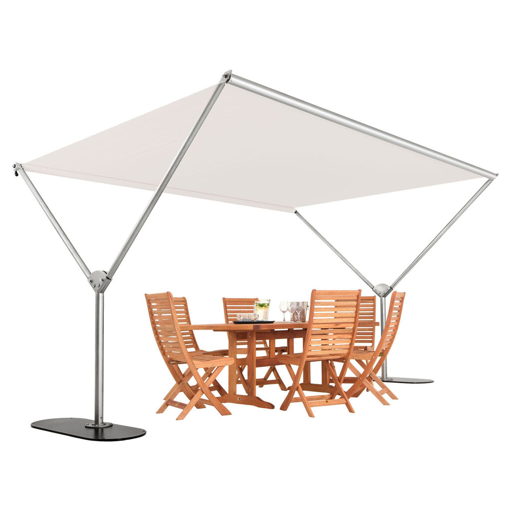 A square cantilever patio umbrella with a beige canopy and silver metal frame, shown with a wooden dining table and four matching chairs underneath on a white background.